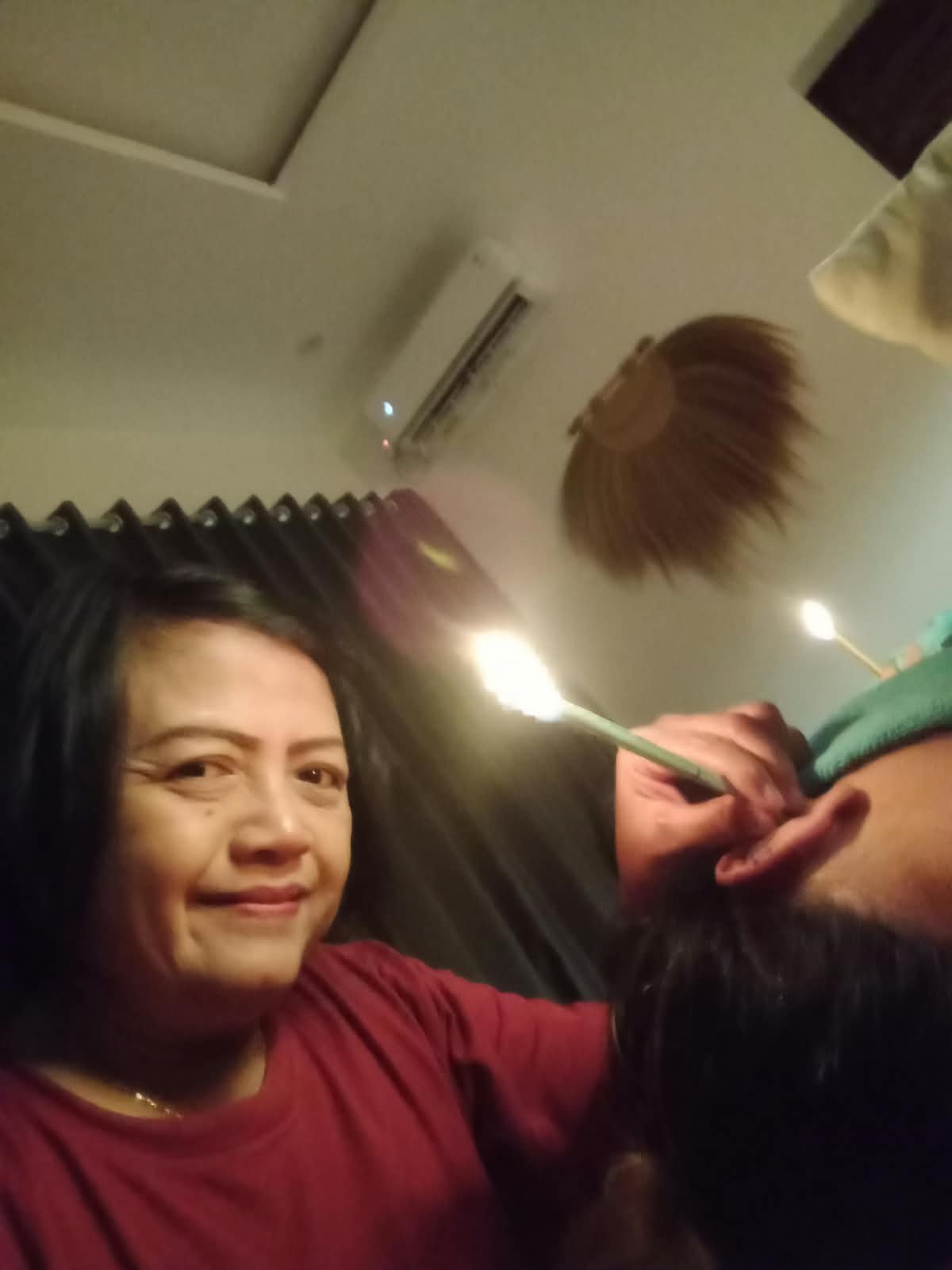 Therapist preparing an ear candle session