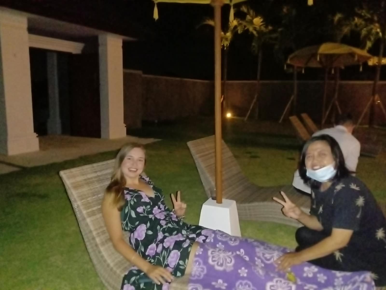 Therapist and guest beside outdoor loungers